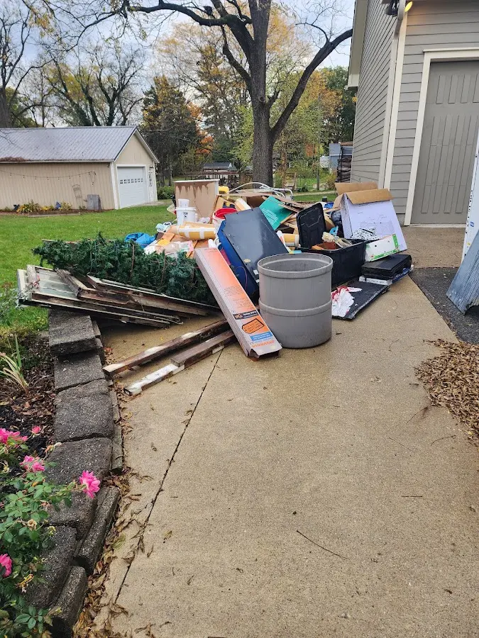 Dumpster being loaded with debris for Demolition Dumpster Rental in Arkansas City